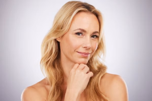Confident middle-aged woman pondering the outcomes of Botox treatment.