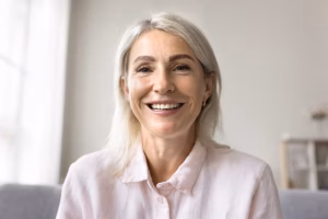 Smiling middle-aged woman with natural facial lines, illustrating facial skin changes after significant weight loss