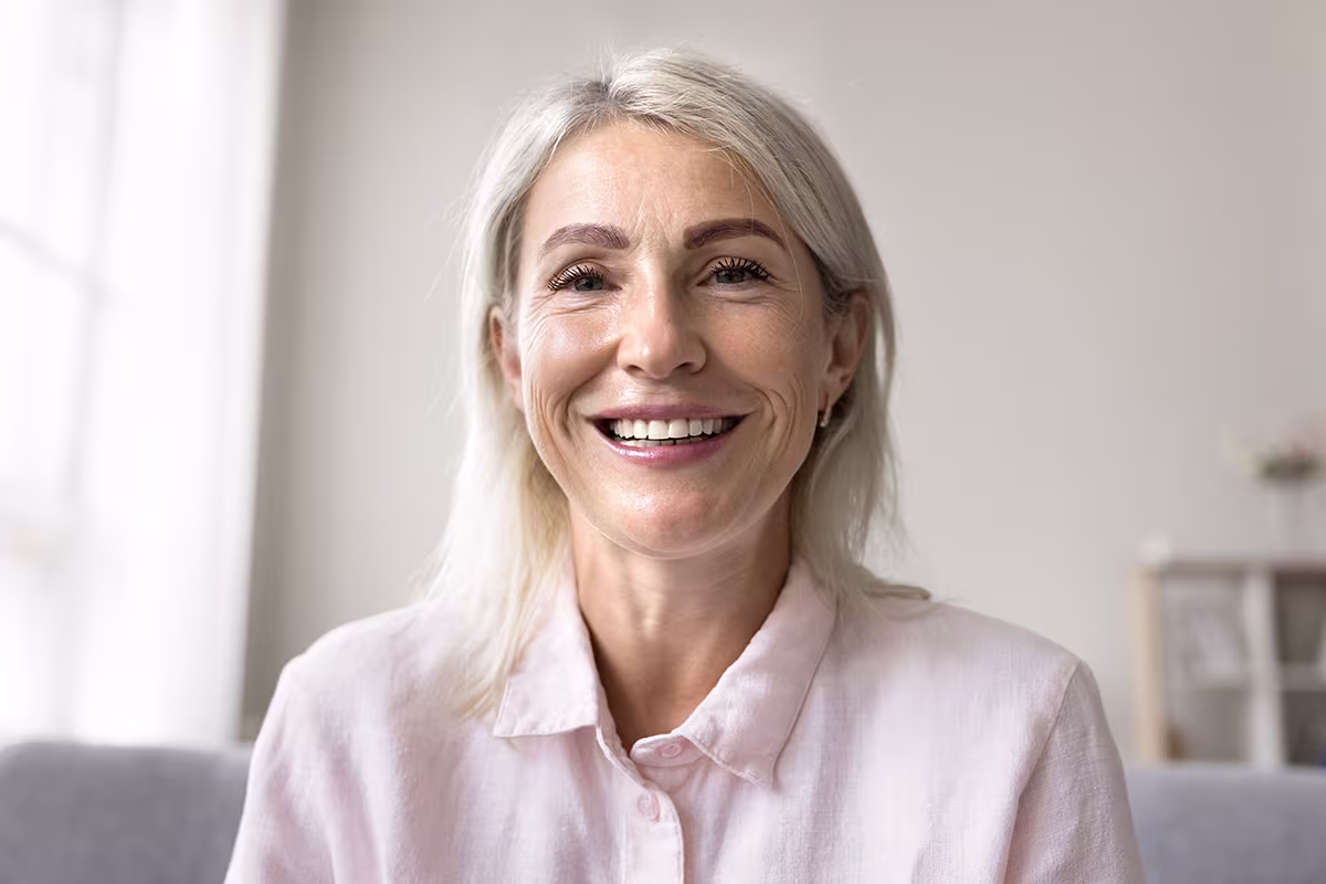 Smiling middle-aged woman with natural facial lines, illustrating facial skin changes after significant weight loss