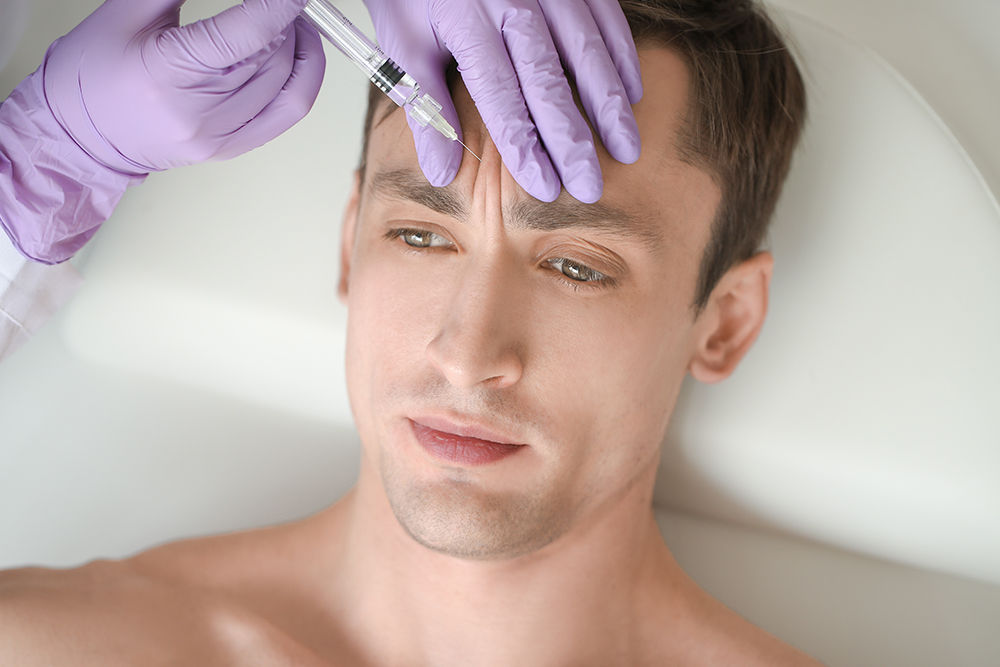 Man receiving Botox injection for forehead lines at cosmetic clinic in Irvine to reduce dynamic wrinkles