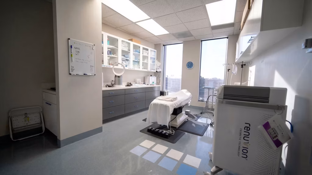 Modern facial plastic surgery procedure room in Orange County clinic with treatment chair and advanced cosmetic equipment.